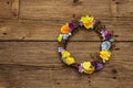 Spring composition of a wreath of birch branches and craft colorful flowers