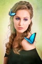 Spring concept of a blonde woman with a blue butterfly on her ha Royalty Free Stock Photo