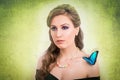 Spring concept of a blonde woman with a blue butterfly Royalty Free Stock Photo