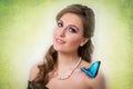 Spring concept of a blonde woman smiling with a blue butterfly Royalty Free Stock Photo