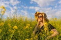 Spring concept.Happy caucasian woman in straw sun hat enjoys a summer walk in yellow flowers field