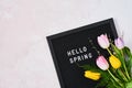Spring concept. Pink and yellow tulips and letterboard with quote Hello Spring Royalty Free Stock Photo