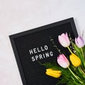 Spring concept. Pink and yellow tulips and letterboard with quote Hello Spring Royalty Free Stock Photo