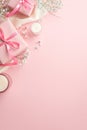 Top view vertical photo of pink present boxes with ribbon bows white soft plaid candles and gypsophila flowers Royalty Free Stock Photo