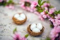 Spring conceptual photo with flowers. Flat lay blooming tree, easter eggs. The tree blooms pink and the eggs in the nest and copy