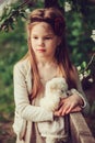 Spring country portrait of adorable dreamy kid girl near wooden fence with teddy bear Royalty Free Stock Photo