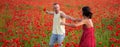 Spring couple in love, banner. Carefree couple in love on poppy spring field. Well being dancing family, country nature Royalty Free Stock Photo