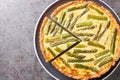 Spring creamy asparagus tart close-up in a plate. Horizontal top view