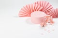 Spring cylinder podium mockup decorated of semicircle asian fans, twig pink sakura flowers, petals on white wood background