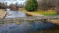 A spring day at the park with the open river and bridge Royalty Free Stock Photo