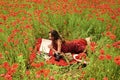 Spring dreams. Girl journalism and writing, summer. Journalism photographer reporter, writer woman in poppy field.