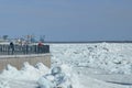 Spring drifting of ice on the Amur River. View of the embankment of the city of Blagoveshchensk, Russia. River port cranes. Large