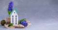 Spring Easter composition with blue hyacinths potted and a miniature wooden house Royalty Free Stock Photo