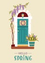 Spring or Easter concept. Decorated vintage entrance door with wisteria, tulips and spring wreath. Traditional spring home Royalty Free Stock Photo