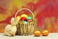 Spring easter holiday, colorful eggs, golden egg in basket, rabbit Royalty Free Stock Photo