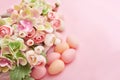 Spring and Easter holiday concept with copy space. Template Easter Greeting Card. Easter eggs and flowers on pink background. Royalty Free Stock Photo