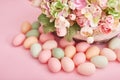 Spring and Easter holiday concept with copy space. Template Easter Greeting Card. Easter eggs and flowers on pink background. Royalty Free Stock Photo