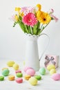 Spring and Easter holiday concept with copy space. Template Easter Greeting Card. Easter eggs and flowers on white background. Royalty Free Stock Photo