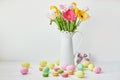 Spring and Easter holiday concept with copy space. Template Easter Greeting Card. Easter eggs and flowers on white background. Royalty Free Stock Photo