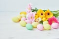 Spring and Easter holiday concept with copy space. Template Easter Greeting Card. Easter eggs and flowers on white background. Royalty Free Stock Photo