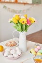 Spring and Easter holiday concept with copy space. Template Easter Greeting Card. Easter eggs and flowers on white background. Royalty Free Stock Photo