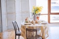 Spring, Easter interior in Scandinavian style. Rustic Living room with bright wardrobe yellow mimosa