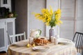 Spring, Easter interior in Scandinavian style. Rustic Living room with bright wardrobe yellow mimosa