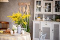 Spring, Easter interior in Scandinavian style. Rustic Living room with bright wardrobe yellow mimosa