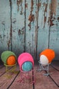 spring easter still life, easter eggs with bird paws and colorful knitted hats