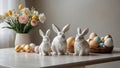 Spring Easter Table with Rabbit Figurines, Colorful Eggs, and Vibrant Flowers Royalty Free Stock Photo