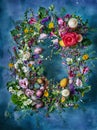 Spring Easter wreath with flowers, herbs, eggs, guinea fowl feathers and candles Royalty Free Stock Photo