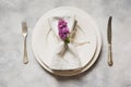 Spring elegant table place setting with violet lilac, silverware on vintage table. View from above. Royalty Free Stock Photo