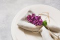 Spring elegant table place setting with violet lilac, silverware on vintage table. View from above. Royalty Free Stock Photo