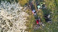 Spring family cycling on bikes aerial top view from above, happy active parents with children have fun and relax on grass Royalty Free Stock Photo