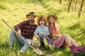 Spring farm work. Happy family rest on green grass. Hobby farm. Farm tourism or agritourism. Gardening and homesteading Royalty Free Stock Photo