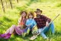 Spring farm work. Happy family rest on green grass. Hobby farm. Farm tourism or agritourism. Gardening and homesteading Royalty Free Stock Photo