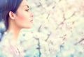 Spring fashion girl in blooming trees Royalty Free Stock Photo