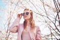 Spring fashion girl outdoors portrait in blooming trees. Beauty Romantic woman in flowers in sunglasses. Sensual Lady. Royalty Free Stock Photo