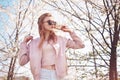 Spring fashion girl outdoors portrait in blooming trees. Beauty Romantic woman in flowers in sunglasses. Sensual Lady. Royalty Free Stock Photo