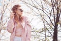 Spring fashion girl outdoors portrait in blooming trees. Beauty Romantic woman in flowers in sunglasses. Sensual Lady. Royalty Free Stock Photo