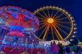 Spring Festival in Munich at the blue hour with a lightened ferris wheel and chain carusel. Royalty Free Stock Photo