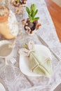 Spring festive dining table setting with flowers, napkins and cute bunny decor on linen tablecloth. Easter time. Cozy home Royalty Free Stock Photo