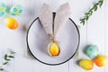 Spring festive Easter table setting with bunny ears linen napkin and kitchen cutlery. Flat lay,