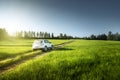 Spring field and blurred car on ground road Royalty Free Stock Photo