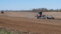 spring field work. the tractor plows the ground. preparation for sowing agricultural crops. farming. Royalty Free Stock Photo