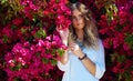 Spring is finally here. an attractive young woman standing under a tree with beautiful pink flowers. Royalty Free Stock Photo