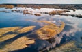 Spring flood rural landscape. Trees, meadow, bushes, fields, country road under High Water inundation. Sky, clouds reflection in Royalty Free Stock Photo