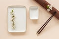 Spring floral Japanese food concept with blooming cherry tree branches and serving with  chopsticks on coral color pastel paper Royalty Free Stock Photo