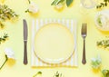 Spring floral table settings with spring flowers. Top view empty plate. Royalty Free Stock Photo