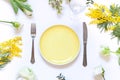 Spring floral table settings with spring flowers. Top view empty plate. Royalty Free Stock Photo